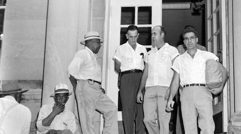 Roy Bryant, right, and J. W. Milam, second from right, walk down the steps of the Leflore County Courthouse in Greenwood, Miss., on Sept. 30, 1955, after being freed on bond in the kidnapping and murder of Emmett Till. Bryant and Milam eventually were acquitted of murdering the 14-year-old black youth in a trial which drew international attention. (AP Photo/File)
