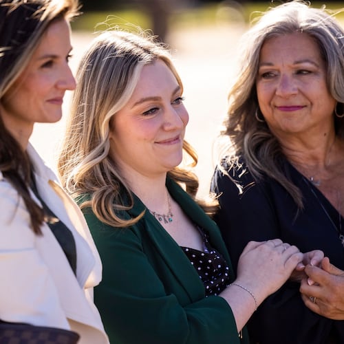 Abigail "Abby" Zwerner smiles with her mother Julie as her lawyers speak to members of the press after a verdict was reached in her lawsuit against the assistant principal, Ebony Parker, of Richneck Elementary School during proceedings at Newport News Circuit Court in Newport News, Va. on Thursday, Nov. 6, 2025. (Kendall Warner/The Virginian-Pilot via AP)