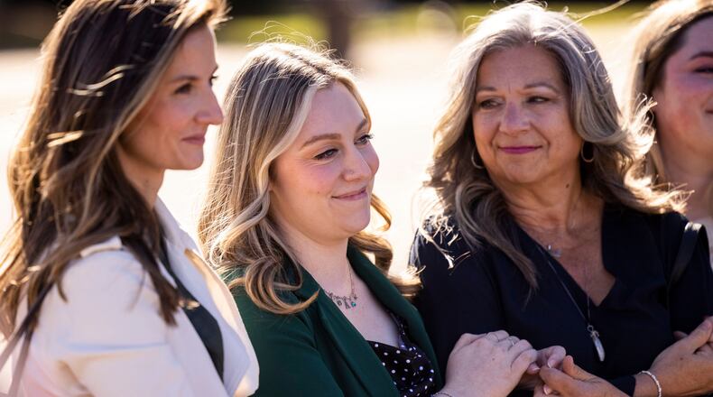 Abigail "Abby" Zwerner smiles with her mother Julie as her lawyers speak to members of the press after a verdict was reached in her lawsuit against the assistant principal, Ebony Parker, of Richneck Elementary School during proceedings at Newport News Circuit Court in Newport News, Va. on Thursday, Nov. 6, 2025. (Kendall Warner/The Virginian-Pilot via AP)