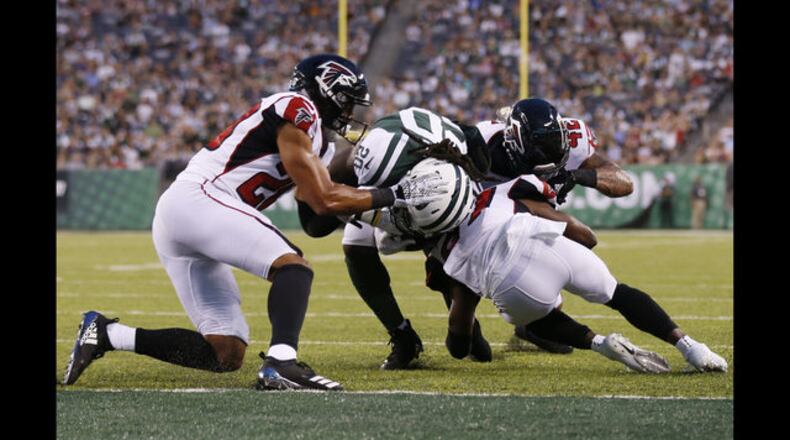 New York Jets running back Isaiah Crowell (20) breaks a tackle by Atlanta Falcons' Isaiah Oliver (20) to score a touchdown during the first half of a preseason NFL football game Friday, Aug. 10, 2018, in East Rutherford, N.J. Riley is behind the play. (AP Photo/Adam Hunger)