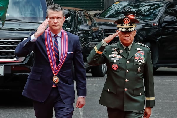 U.S. Defense Secretary Pete Hegseth, along with Armed Forces of the Philippines Chief of Staff General Romeo Brawner, salute the troops upon arriving at the AFP headquarters Camp Aguinaldo, in Quezon City, Philippines, Friday, March 28, 2025. (AP Photo/Gerard V. Carreon, Pool)