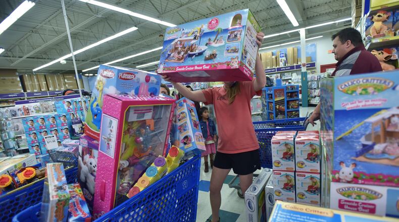 Helping out Santa: Jamie Staveness picks up a big box of a toy that was on someone's Christmas list.