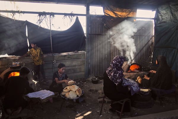 Displaced Palestinians bake bread in a school now serving as a shelter in Deir al-Balah, Gaza Strip Sunday, July 6, 2025. (AP Photo/Abdel Kareem Hana)