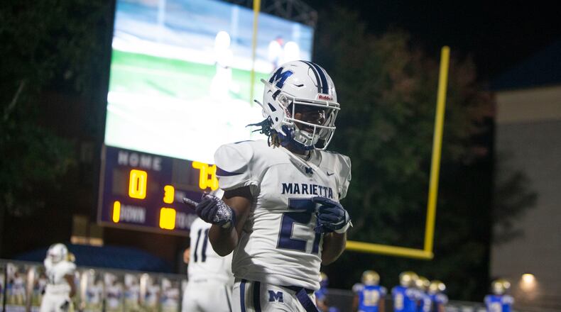 Jace Arnold, corner for Marietta, celebrates his touchdown during the Marietta vs. McEachern High School Football game on Friday, October 14, 2022, at McEachern High School in Powder Springs, Georgia. Marietta defeated McEachern 34-16.  CHRISTINA MATACOTTA FOR THE ATLANTA JOURNAL-CONSTITUTION.