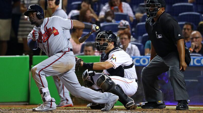 Adonis Garcia #13 of the Atlanta Braves hits a two-RBI single in the eighth inning during a game against the Miami Marlins at Marlins Park on April 15, 2016 in Miami, Florida. (Photo by Mike Ehrmann/Getty Images)