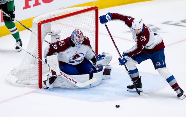Colorado Avalanche defenseman Devon Toews (7) stops a shot in front of goaltender Mackenzie Blackwood (39) during a first-round NHL hockey playoff game against the Dallas Stars in Dallas, Saturday, April 19, 2025. (AP Photo/Gareth Patterson)