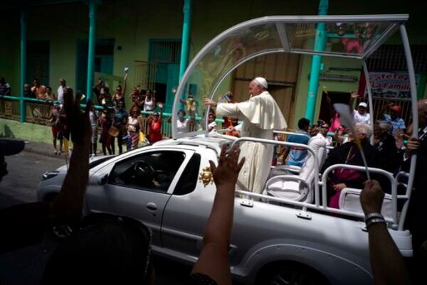 FILE - People wave to Pope Francis as he leaves the Metropolitan Cathedral, in route to the airport in Santiago de Cuba, Cuba, on Tuesday, Sept. 22, 2015. (AP Photo/Ramon Espinosa, file)