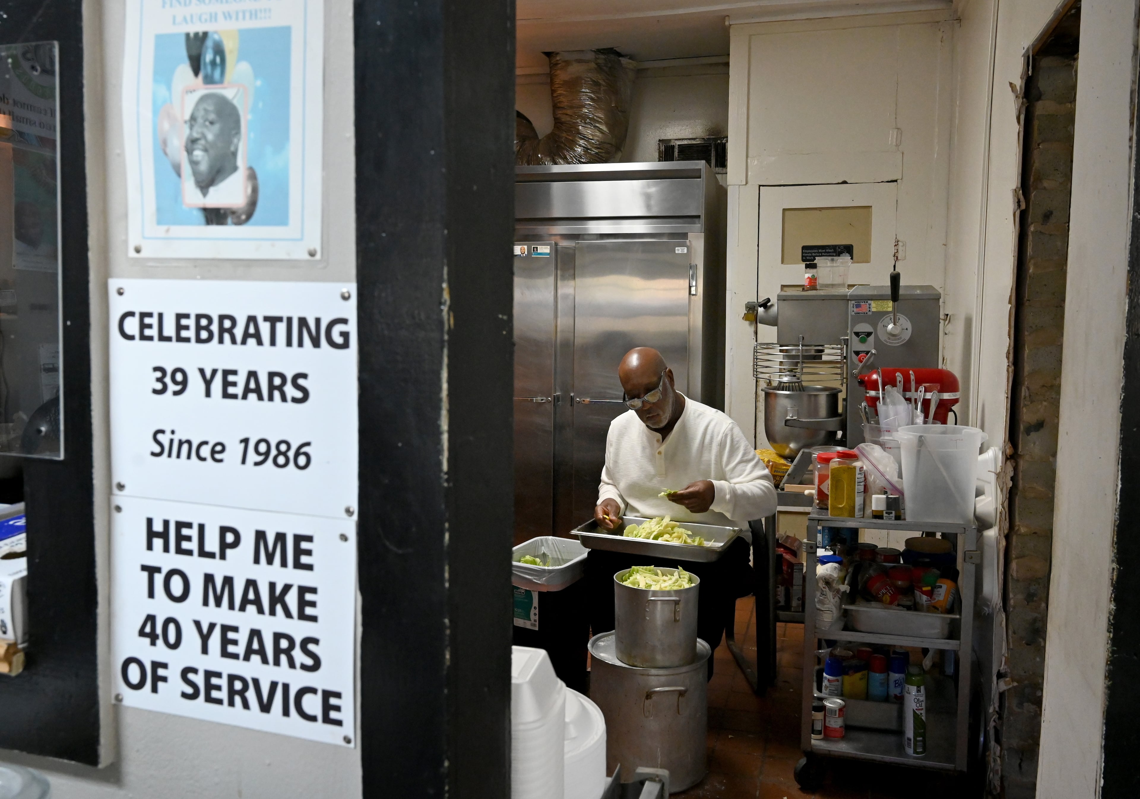 Dexter Weaver prepares food before opening his restaurant for lunch customers on Wednesday, Nov. 12, 2025. (Hyosub Shin/AJC)