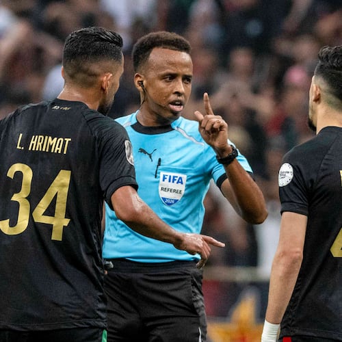 Referee Omar Artan, center, of Somalia, is confronted by players after calling a penalty kick during the CAF Champions League final soccer match between AS FAR Rabat and Mamelodi Sundowns, in Rabat, Morocco, Sunday, May 24, 2026. (AP Photo/Mosa'ab Elshamy)