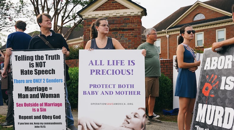 Protesters from Operation Save America canvas outside of an abortion clinic in Forest Park in July. (Olivia Bowdoin for The Atlanta Journal-Constitution)