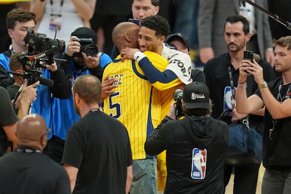 Indiana Pacers guard Tyrese Haliburton hugs NBA hall of fame Reggie Miller, left, after Game 6 of the NBA Finals basketball series against the Oklahoma City Thunder, Thursday, June 19, 2025, in Indianapolis. (AP Photo/Michael Conroy)