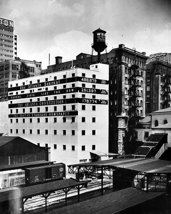 In this photo from 1959, the back of the 10 Forsyth building advertises the papers’ circulation figures, as well as WSB on the water tower. (AJC file)