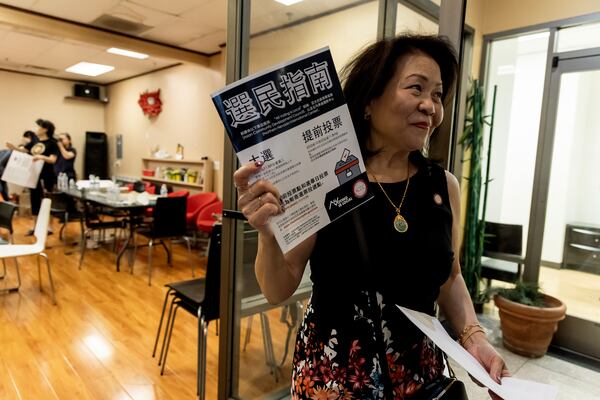 Vida Lin, president and founder of the Asian Community Development Council, holds a voter information booklet her group translated into Chinese at the annual Dragon Boat Festival in Las Vegas on Wednesday, June 5, 2024. (Photo by Christopher Lomahquahu/News21)