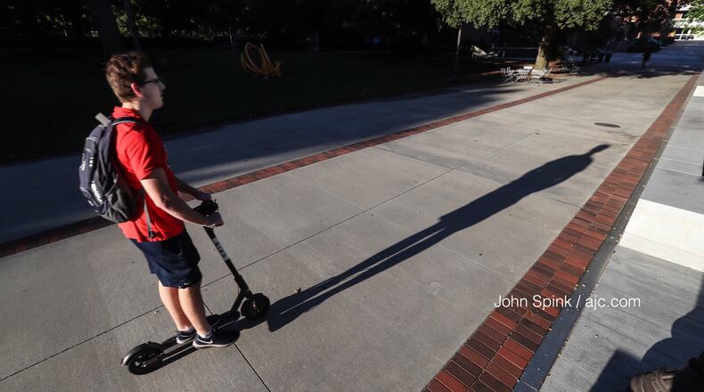 Jack Hearn, 20, a third-year civil engineering major at Georgia Tech, rides a Bird scooter on campus. JOHN SPINK / JSPINK@AJC.COM
