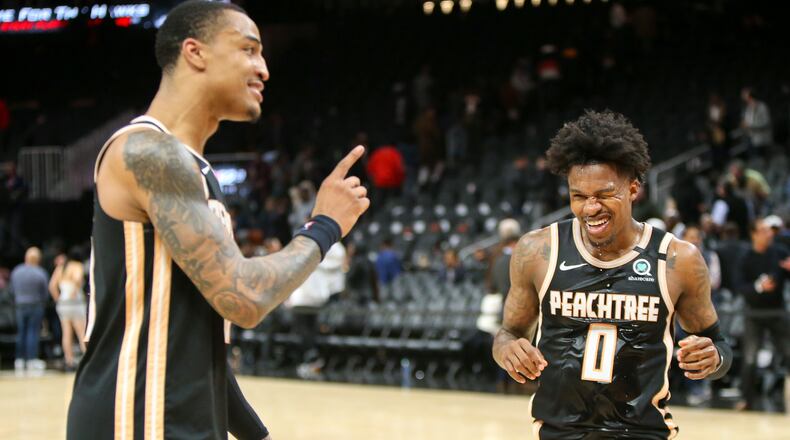Hawks forward John Collins (20) and guard Brandon Goodwin (0) celebrate after a  victory. (AP Photo/Brett Davis)