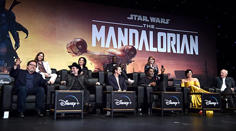 HOLLYWOOD, CALIFORNIA - NOVEMBER 13: (L-R) Executive Producer Jon Favreau, Composer Ludwig Göransson, Executive Producer/Director Dave Filoni, Director Deborah Chow, Pedro Pascal, Rick Famuyiwa, Carl Weathers, Director Bryce Dallas Howard, Gina Carano and Werner Herzog speak onstage at the premiere of Lucasfilm's first-ever, live-action series, "The Mandalorian," at the El Capitan Theatre in Hollywood, Calif. on November 13, 2019. "The Mandalorian" streams exclusively on Disney+. (Photo by Alberto E. Rodriguez/Getty Images for Disney)