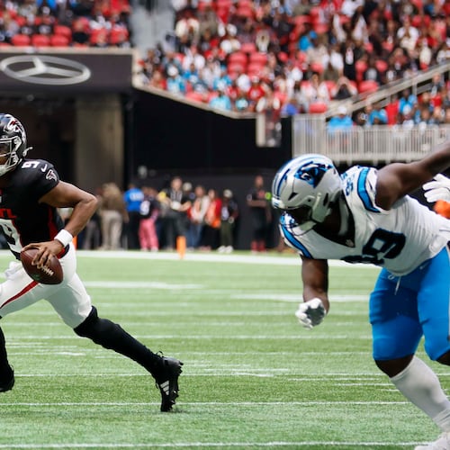 Atlanta Falcons quarterback Michael Penix Jr. went out with a knee injury late in the third quarter with the team still ahead. The Falcons lost to the Panthers in overtime, 30-27. (Miguel Martinez/AJC)