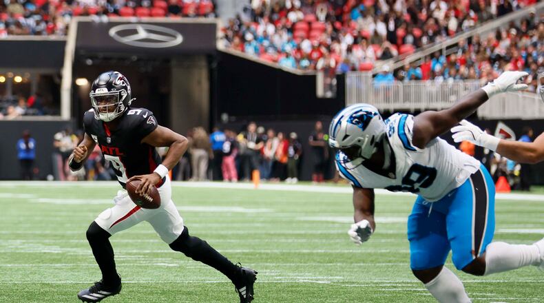 Atlanta Falcons quarterback Michael Penix Jr. went out with a knee injury late in the third quarter with the team still ahead. The Falcons lost to the Panthers in overtime, 30-27. (Miguel Martinez/AJC)
