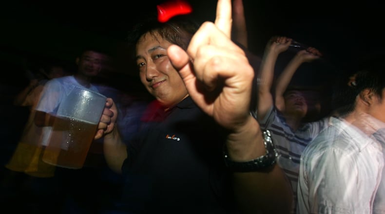 People enjoy beer at a party during the beer festival in Qingdao, Shandong Province of China.