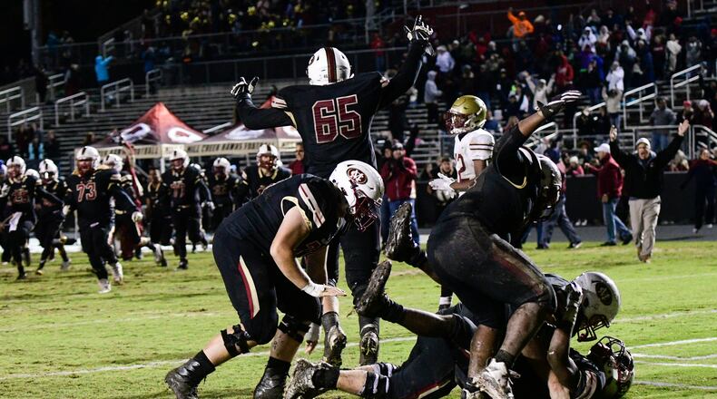 Mill Creek players celebrate a touchdown by RB Joshua Battle during overtime to win Friday's game against Brookwood. (John Amis/Special)
