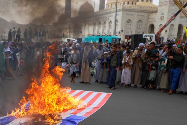 Houthi supporters burn an American and an Israeli flags during an anti-U.S. and anti-Israel rally in Sanaa, Yemen, Friday, April 18, 2025. (AP Photo/Osamah Abdulrahman)