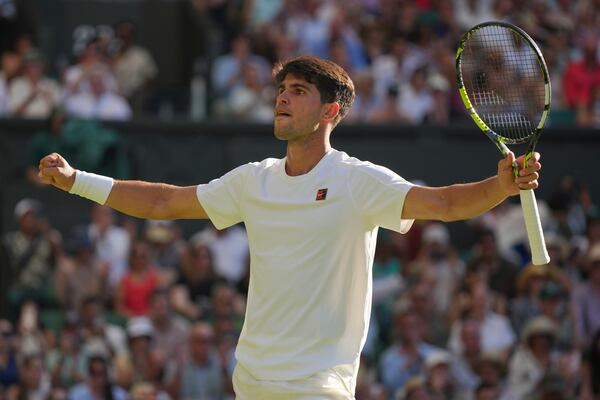 Carlos Alcaraz of Spain celebrates after beating Fabio Fognini of Italy during their first round men's singles match at the Wimbledon Tennis Championships in London, Monday, June 30, 2025. (AP Photo/Alastair Grant)