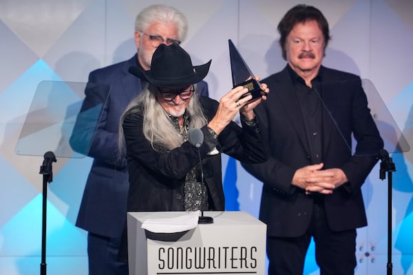 Michael McDonald, from left, Patrick Simmons, and Tom Johnston of The Doobie Brothers accept an award during the 54th annual Songwriters Hall of Fame induction and awards gala on Thursday, June 12, 2025, at the Marriott Marquis Hotel in New York. (Photo by Charles Sykes/Invision/AP)