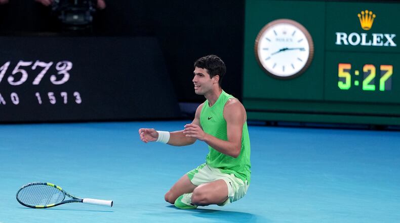 Carlos Alcaraz of Spain celebrates after defeating Alexander Zverev of Germany in their semifinal match at the Australian Open tennis championship in Melbourne, Australia, Friday, Jan. 30, 2026. (AP Photo/Asanka Brendon Ratnayake)
