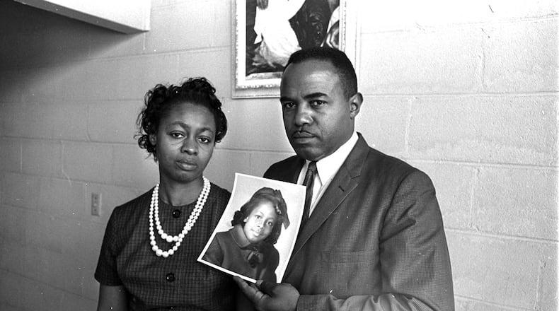 Mr. and Mrs. Chris McNair hold a picture of their daughter, Denise, 11, in Birmingham on Sept. 16, 1963, as they tell a reporter about the bombing of the 16th Street Baptist Church.