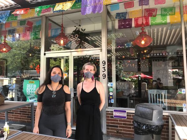 Jarina Naone (left) and Rosa Thurnher, co-owners of El Ponce restaurant and El Bar, a dance club located in the rear lower level of the building at 939 Ponce de Leon Ave., pictured in 2020 during the pandemic. (Ligaya Figueras/AJC)