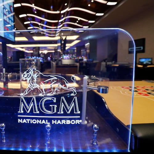 FILE - The MGM National Harbor logo is seen around a roulette wheel in the casino during a preview tour of the MGM National Harbor, Dec. 2, 2016 in Oxon Hill, Md. (AP Photo/Alex Brandon, File)