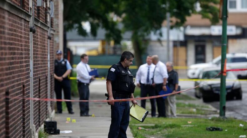 Chicago police officers and detectives investigate a shooting where multiple people were shot Sunday.