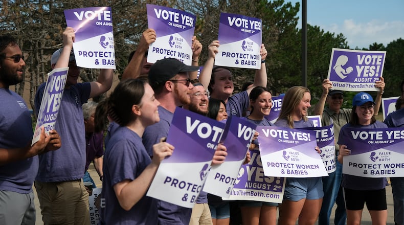 Supporters of the group Value Them Both, who support Amendment 2, in Shawnee, Kan., July 30, 2022. Millions of dollars’ worth of advertising has flooded the airwaves in Kansas, part of a sudden burst of attention and spending as voters prepare for the country’s first electoral test addressing abortion since the Supreme Court struck down Roe v. Wade. (Arin Yoon/The New York Times)