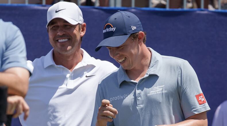 Brooks Koepka and Matt Fitzpatrick, of England, talk before teeing off on the first hole during the first round of the PGA Zurich Classic golf tournament, Thursday, April 23, 2026, in Avondale, La. (AP Photo/Matthew Hinton)
