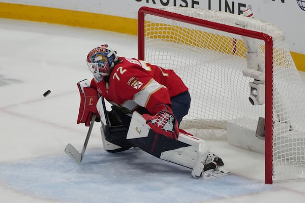 Florida Panthers goaltender Sergei Bobrovsky (72) deflects a shot on goal during the third period in Game 4 of the NHL hockey Stanley Cup Eastern Conference finals against the Carolina Hurricanes, Monday, May 26, 2025, in Sunrise, Fla. (AP Photo/Lynne Sladky)