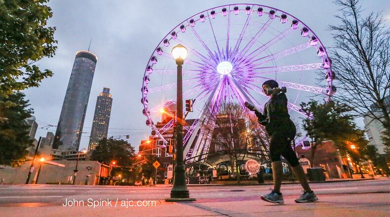 Kendra Reed gets in her 45-minute workout as she walks by SkyView Atlanta in downtown. JOHN SPINK / JSPINK@AJC.COM