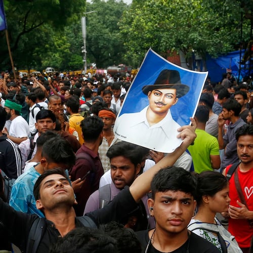 A supporter of the Cockroach Janta Party holds posters of Bhagat Singh, an Indian revolutionary freedom fighter, at Jantar Mantar in New Delhi, Tuesday, July 21, 2026. (AP Photo/Shekhar Yadav)