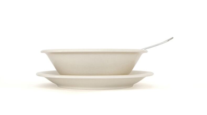 Beige soup plate with spoon and saucer side view (Dreamstime/TNS)