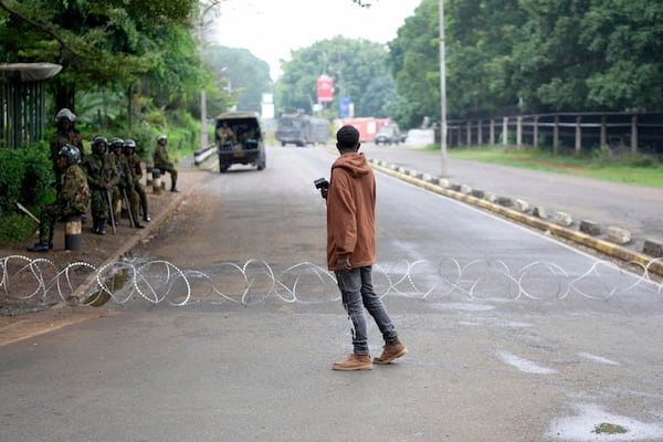 Kenya anti-riot police barricade roads to Parliament buildings with razor wire, ahead of the historic 1990 Saba Saba, a Swahili word that means seven seven, protests for democratic reforms in Nairobi, Kenya Monday, July 7, 2025. (AP Photo/Brian Inganga)