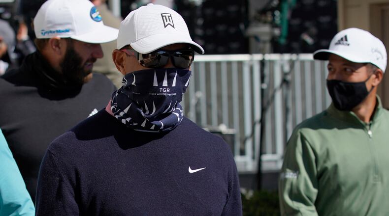 Tiger Woods (center) looks on during the third round of the Genesis Invitational golf tournament at Riviera Country Club, Saturday, Feb. 20, 2021, in the Pacific Palisades area of Los Angeles. (Ryan Kang/AP)