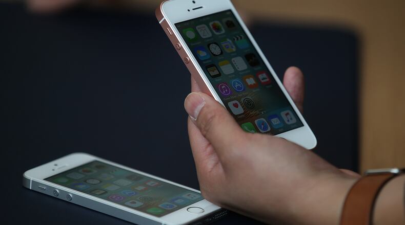 CUPERTINO, CA - MARCH 21: An attendee inpsects the new iPhone SE during an Apple special event at the Apple headquarters on March 21, 2016 in Cupertino, California. Apple announced the iPhone SE and a 9.7" version of the iPad Pro. (Photo by Justin Sullivan/Getty Images)