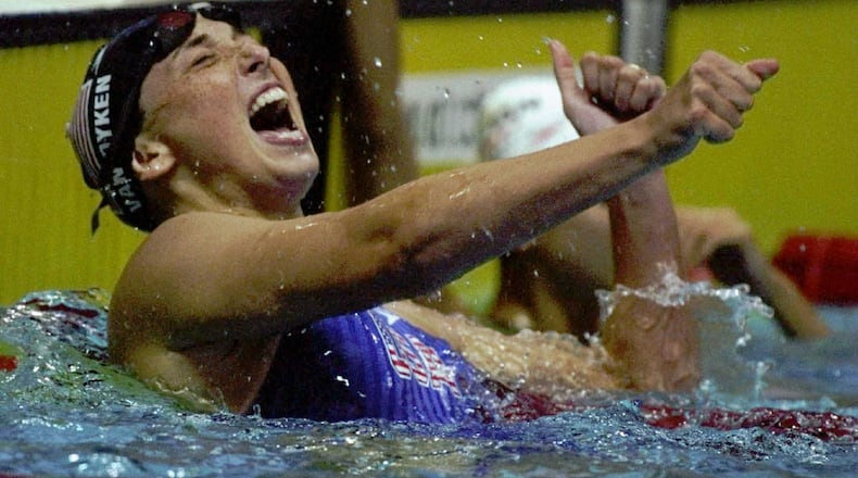 Amy van Dyken of the USA celebrates winning the gold medal in the women’s 100-meter butterfly at the Georgia Tech Aquatic Center at the 1996 Centennial Olympic Games in Atlanta. (Credit: Al Bello /Allsport)