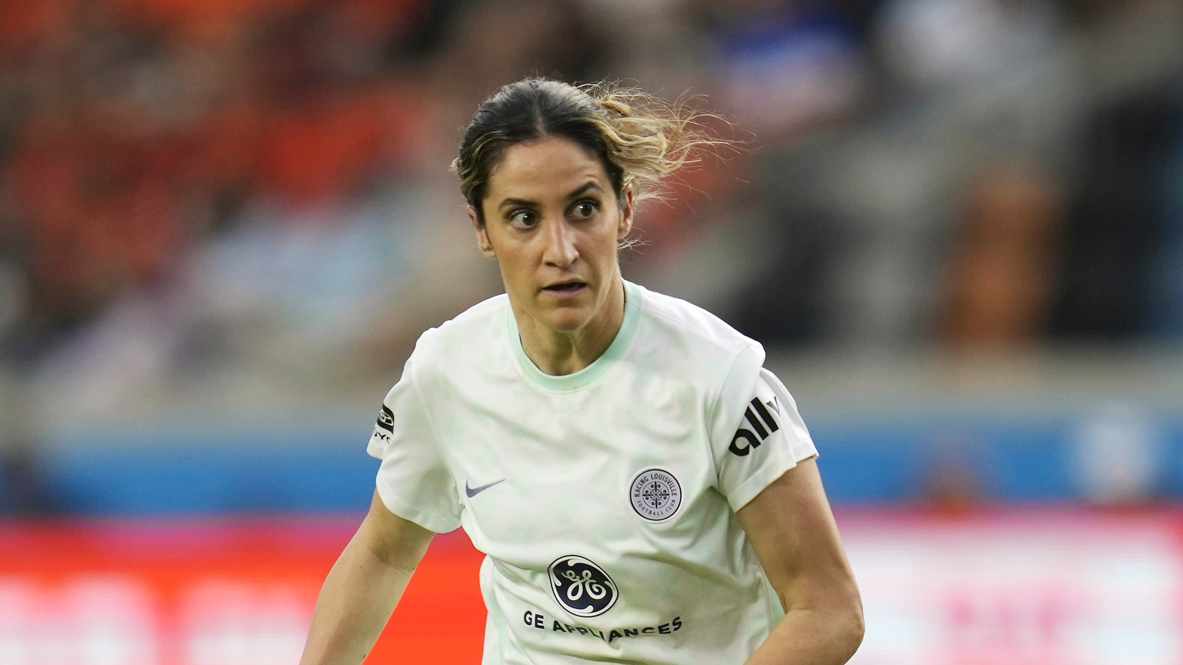 FILE - Racing Louisville FC midfielder Savannah DeMelo (7) looks for a pass against the Houston Dash during an NWSL soccer match, on March 26, 2023, in Houston. (AP Photo/Sam Craft, File)