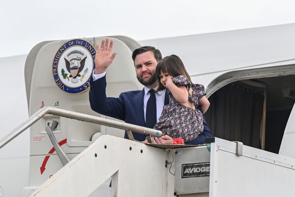 Vice President JD Vance disembarks Air Force Two while carrying his daughter Mirabel, upon arriving at G.B. Pastine–Rome Ciampino Airport, Friday April 18, 2025. (Kenny Holston/The New York Times via AP, Pool)