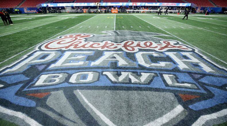 The Chick-fil-A Peach Bowl logo adorns the Mercedes-Benz Stadium fiield before the game between the UCF Knights and the Auburn Tigers Monday, Jan. 1, 2018, in Atlanta.