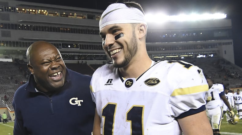 Georgia Tech quarterback Matthew Jordan walks off the Lane Stadium field with team chaplain Derrick Moore after leading the Yellow Jackets to an upset win over the Hokies last November in Blacksburg, Va. (GETTY IMAGES)