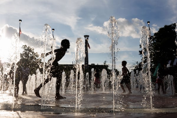 Young kids play at a splash pad at the FIFA Fan Fest in Centennial OLympic Park in Atlanta on June 27, 2026. (Estela Muñoz/AJC). 