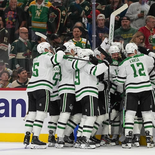 Dallas Stars players celebrate after the double overtime win against the Minnesota Wild of Game 3 in the first round of the NHL Stanley Cup hockey playoffs early morning Thursday, April 23, 2026, in St. Paul, Minn. (AP Photo/Abbie Parr)