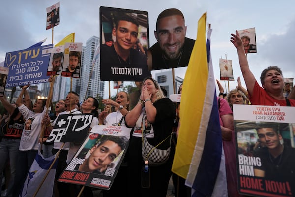 FILE - People watch a live broadcast of Israeli-American soldier Edan Alexander's release from Hamas captivity at a plaza known as the hostages square in Tel Aviv, May 12, 2025. (AP Photo/Oded Balilty, File)