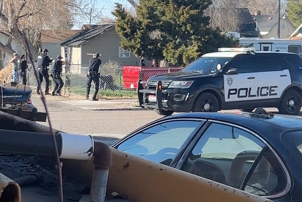 In this image made from video, police are seen shortly before opening fire on a teen on the other other side of a fence Saturday, April 5, 2025, in Pocatello, Idaho. (Brad Andres via AP)